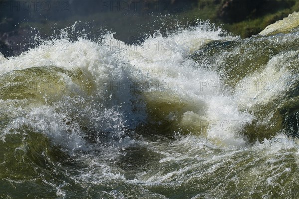 Waterfall plunges into the river