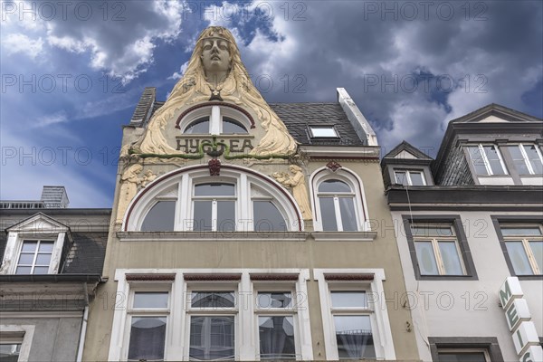 Art Nouveau facade of a residential and commercial building with sculpture of the Virgin Mary