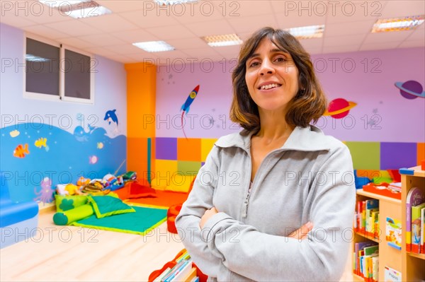 Portrait of a kindergarten or early childhood education teacher inside a kindergarten nursery