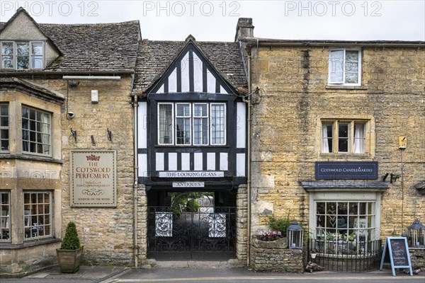 Typical stone houses and half-timbered houses in the Cotswolds with row of shops