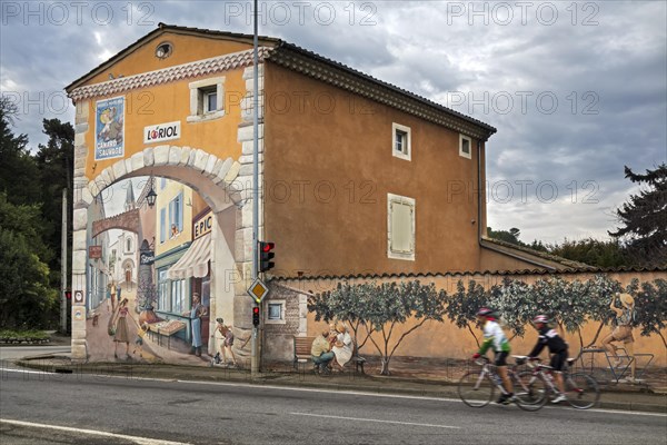 Old painted advertisement for nougat Canard Sauvage and trompe-l'oeil mural on wall along the historic Route Nationale 7