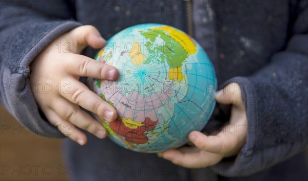 Save the Earth. Child holding a globe in the band