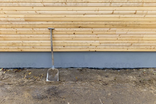 A shovel is leaning against a wall at a construction site. Berlin