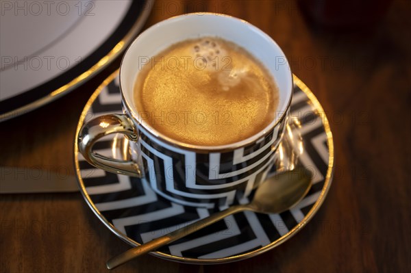 Breakfast with a coffee in a luxurious cup.