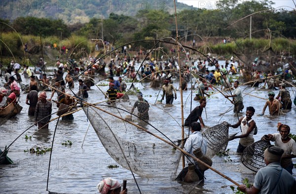 Villagers participate in a community fishing event on the occasion of Bhogali Bihu Festival at Goroimari Lake in Panbari village