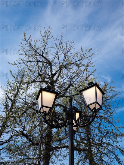 Old street lamp against a blue sky