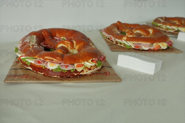 Large pretzel with cheese and sausage