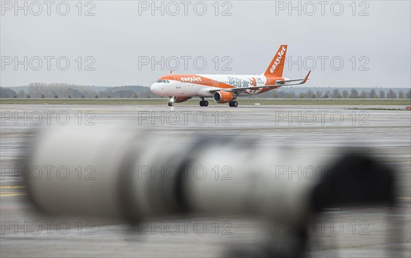An EasyJet aircraft with the inscription Berlin taxis across the tarmac at BER Airport. Schoenefeld