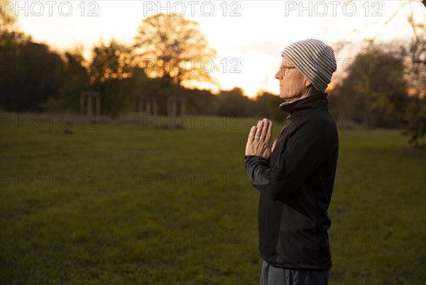 Man doing yoga in the evening light