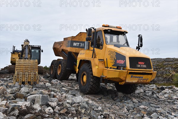 Tracked excavator and dump truck for road construction in Norway