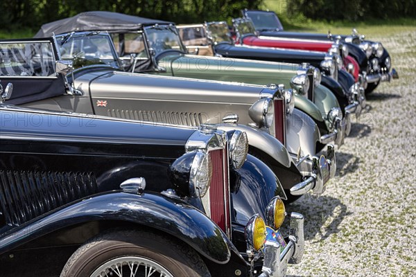 Various classic cars behind each other