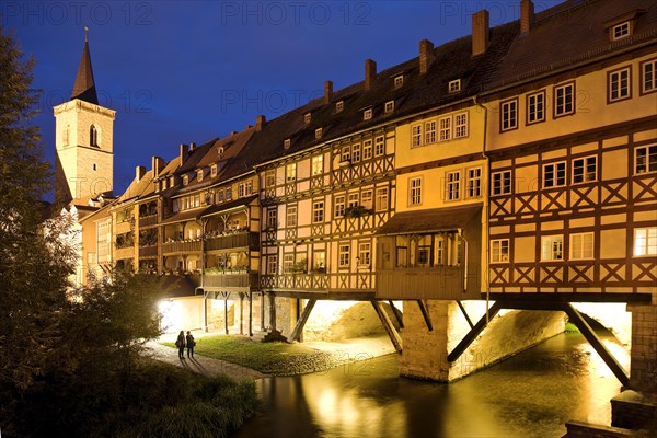 Half-timbered houses of the Kraemerbruecke with the river Gera and the Aegidienkirche in the evening