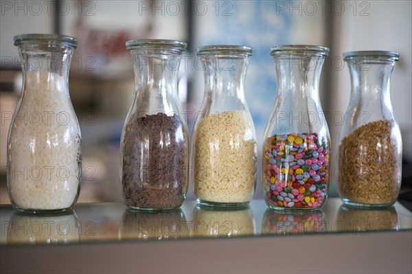 Cereals in decorative bottles in an ice cream parlour