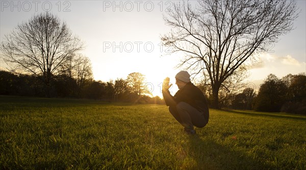 Man stretching in a meadow in autumn. Bonn