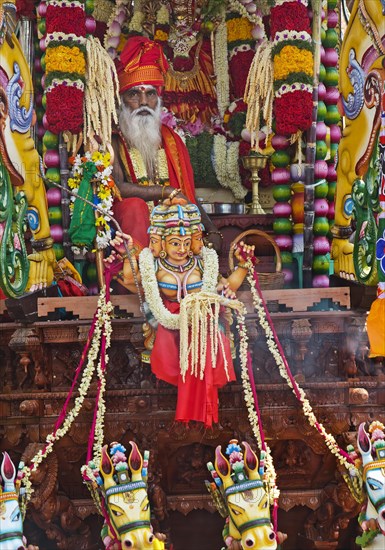 Priest Arumugam Paskaran at the main festival day during the big procession Theer