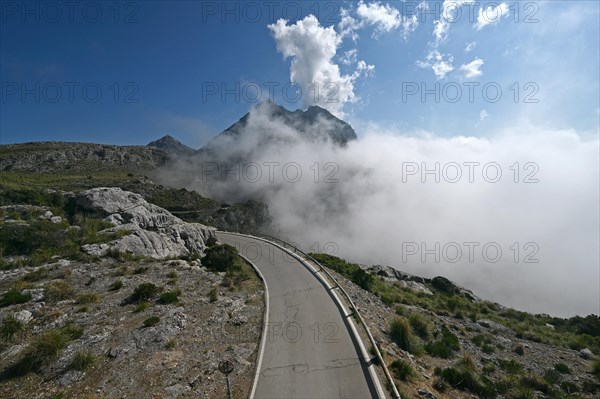 The winding road from Sa Calobra to Coll dels Reis in the Tramuntana Mountains with clouds