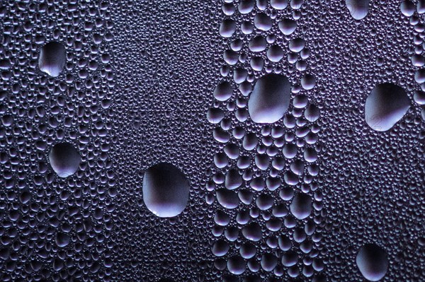 Drops stand out on a window pane in Berlin