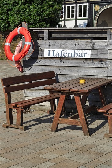 Wooden seating group on terrace of a bar