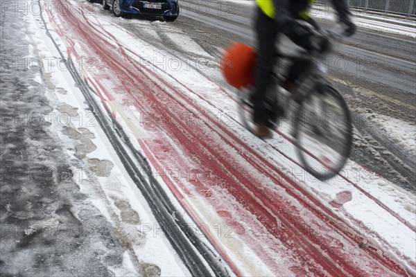 Motion blurred cyclist cycling on slippery bike path