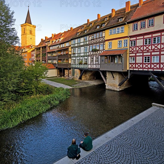 Half-timbered houses of the Kraemerbruecke with the river Gera and the Aegidienkirche