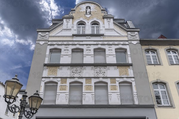 Art Nouveau facade of a residential and commercial building with sculpture of the Virgin Mary