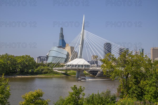 View from the Tache Promenade of the Red River with Provencher Bridge and the Winnipeg skyline behind it