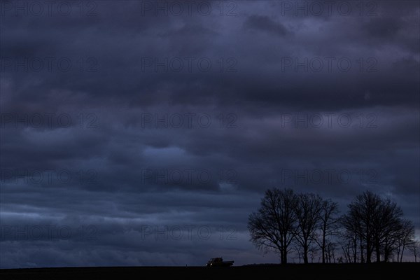 A van stands out at blue hour on a country road in Vierkirchen