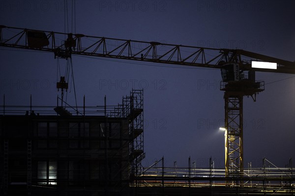 Cranes loom at a construction site in Berlin