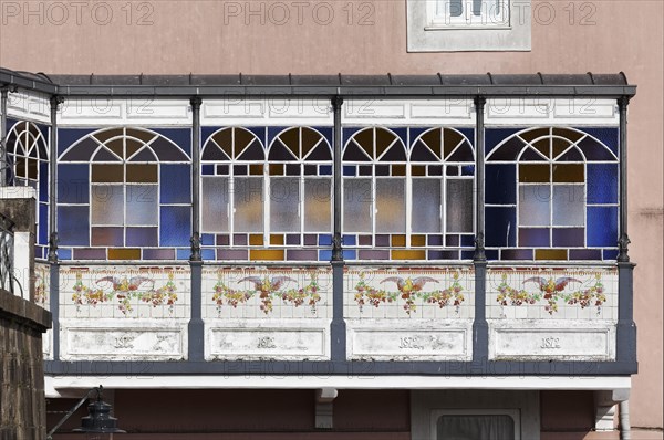 Bay window with stained glass windows and painted tiles