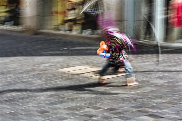 Colourful clown doing a cartwheel