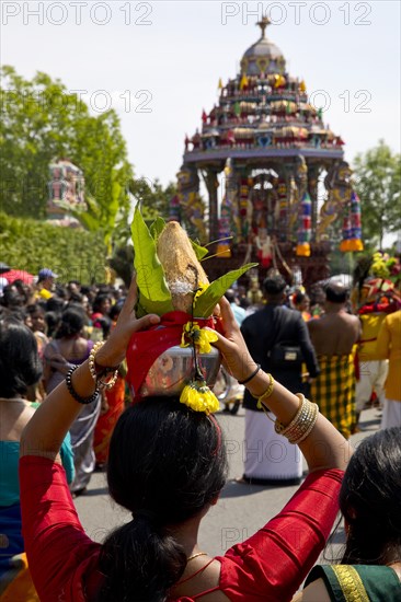 Woman in sari with offerings to the goddess on the main festival day at the big procession Theer