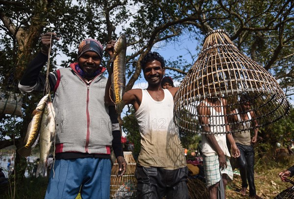 Villagers participate in a community fishing event on the occasion of Bhogali Bihu Festival at Goroimari Lake in Panbari village