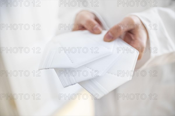 Symbol photo on the subject of FFP2 masks. A woman holds three FFP2 masks in her hands. Berlin