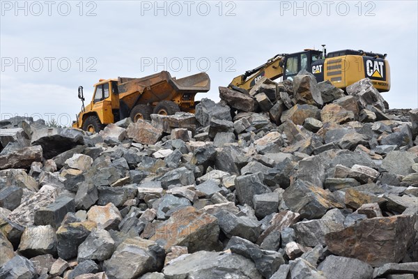 Tracked excavator and dump truck for road construction in Norway