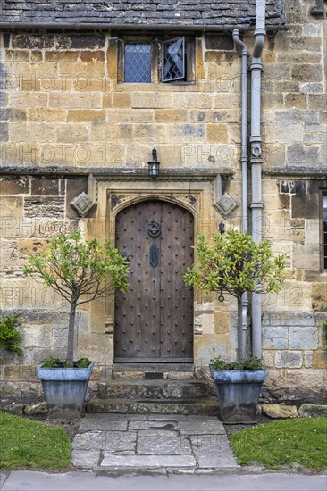 Old stone house in detail with old wooden front door