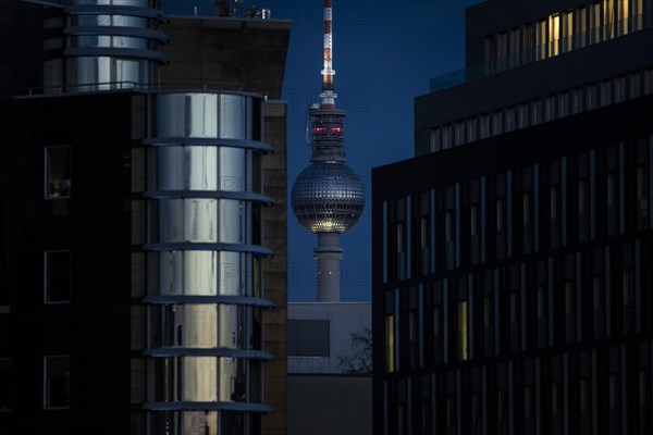 The TV tower looms behind office buildings in Berlin