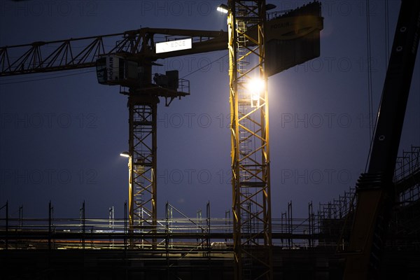 Cranes loom at a construction site in Berlin