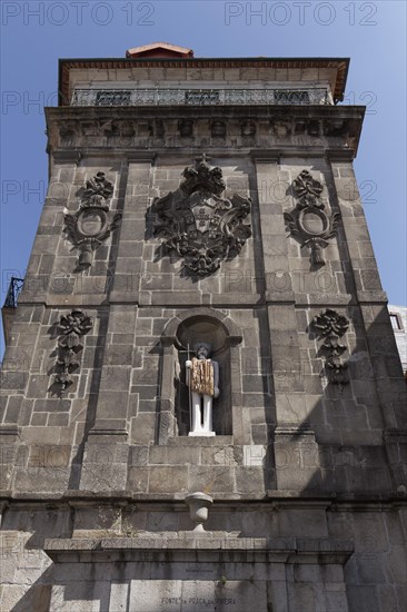 Monumental fountain Fonte da Praca da Ribeira with modern sculpture St. John the Baptist