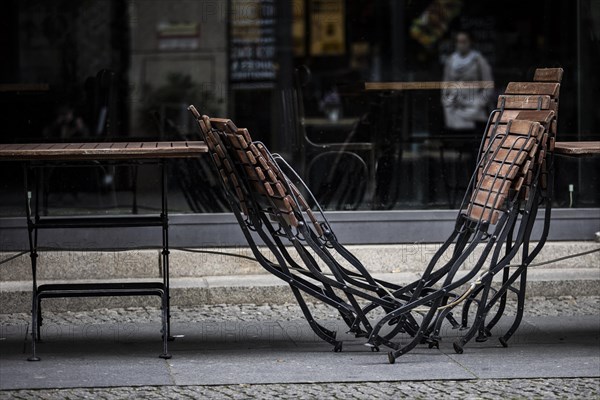Chairs are lined up in front of a restaurant in Berlin