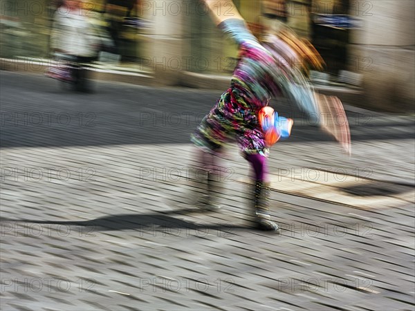 Colourful clown doing a cartwheel