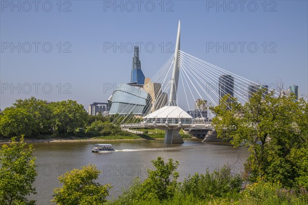 View from the Tache Promenade of the Red River with Provencher Bridge and the Winnipeg skyline behind it