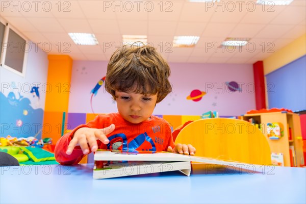 Portrait of a child sitting reading a story book