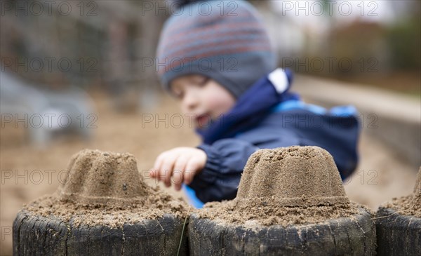 Child sitting alone in a playground.