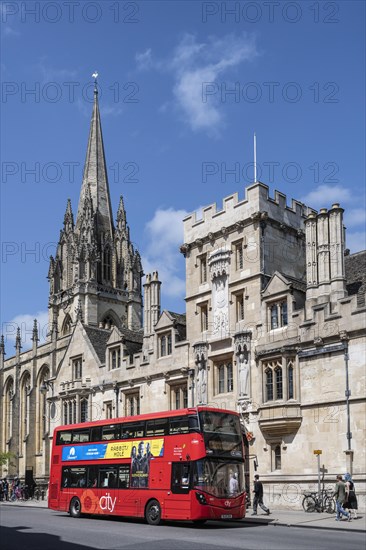 Double decker bus in front of All Souls College on the right and St Mary's Church on the left on the High Street in the Old Town of Oxford