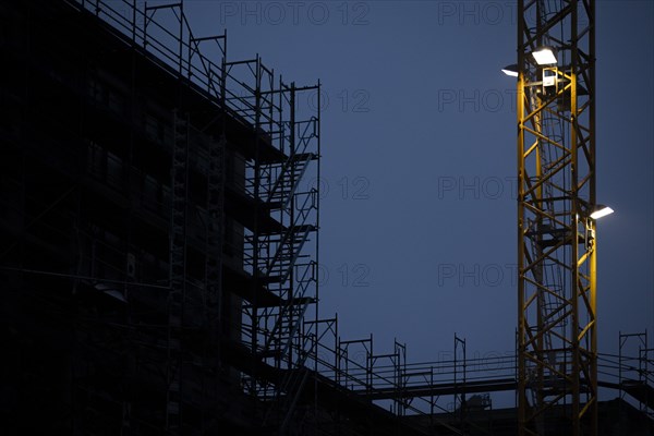 Cranes loom at a construction site in Berlin