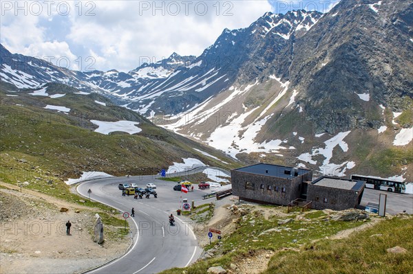 View of curves of pass road mountain road alpine road and car park on Austrian territory of Austria immediately in front of pass height of 2509 metres high alpine pass Timmelsjoch at state border to South Tyrol Italy