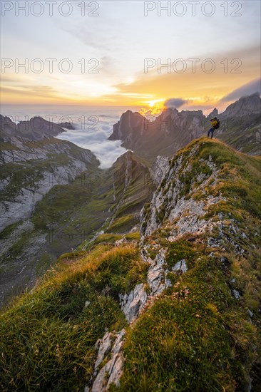 Mountaineer at sunrise on the Rotstein Pass