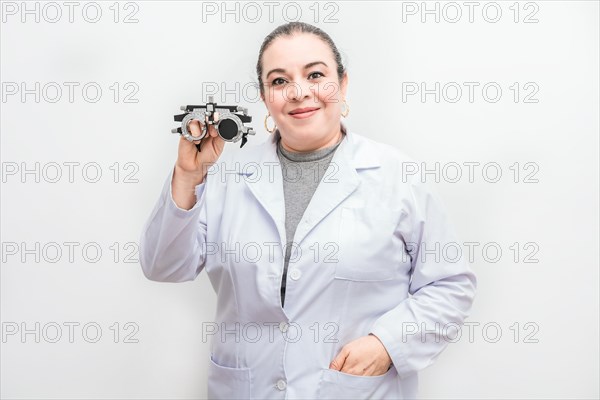 Portrait of female optometrist holding a messbrille lens isolated. Smiling ophthalmologist holding a messbrille isolated