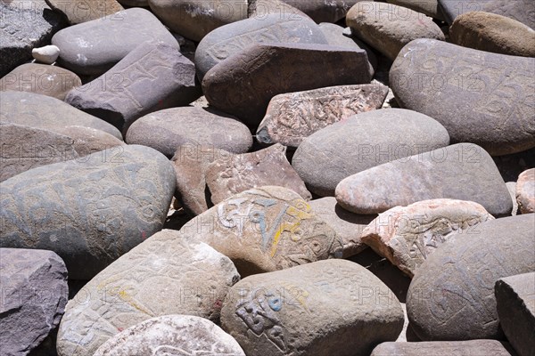 Mani stones with the engraved Tibetan mantra Om Mani Padme Hum