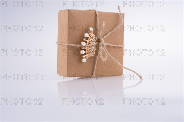 Golden color crown model with pearls on white background